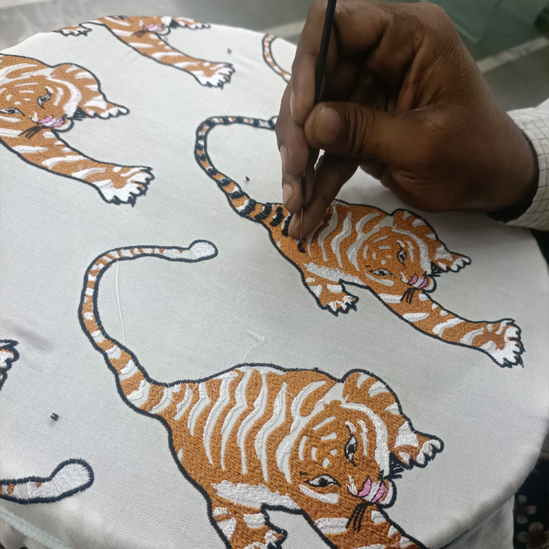Celebrating craftsmanship, images of the Courageous Tiger being embroidered